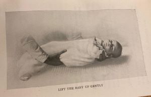 Photograph showing how to lift a baby, from The Canadian Mother's Book, 1923
