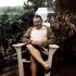 Ernest Hemingway sitting on a deck chair with a book at his home, Finca Vigia, San Francisco de Paula, Cuba.